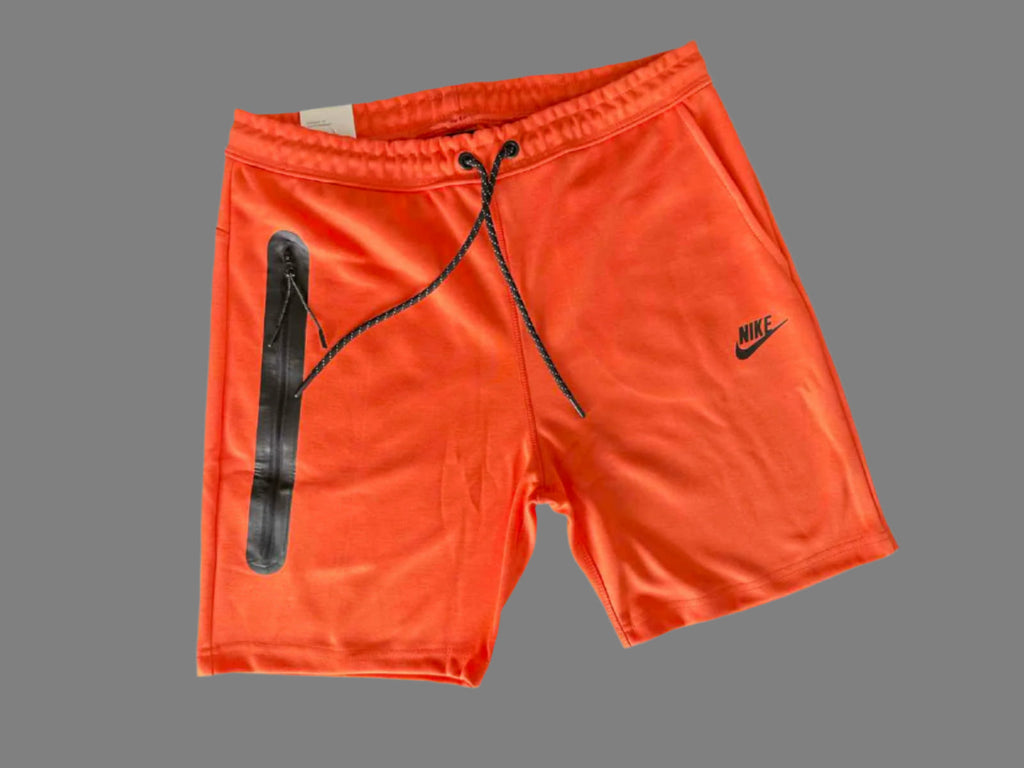 pánske športové krátke nohavice Nike Tech Fleece, oranžové farby.